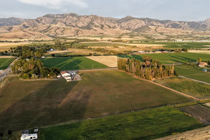 Expansive agricultural landscape with diverse fields and distant mountain ranges
