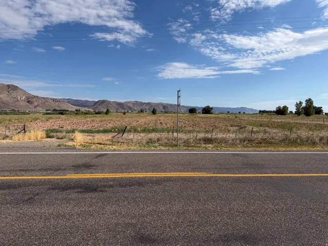 Expansive land parcel with distant mountain ranges and a clear sky backdrop