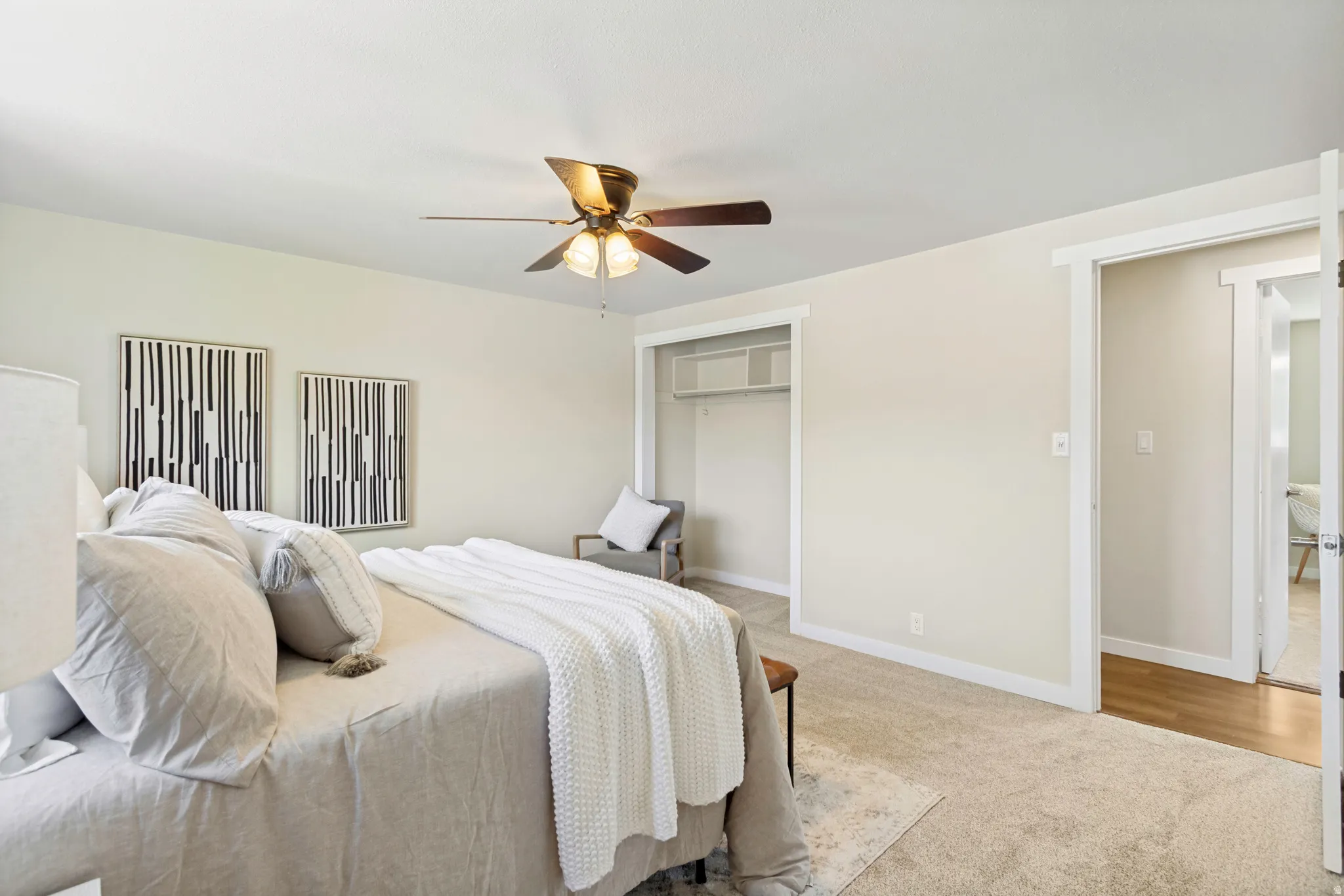Spacious Primary bedroom featuring neutral carpeting and light-toned walls