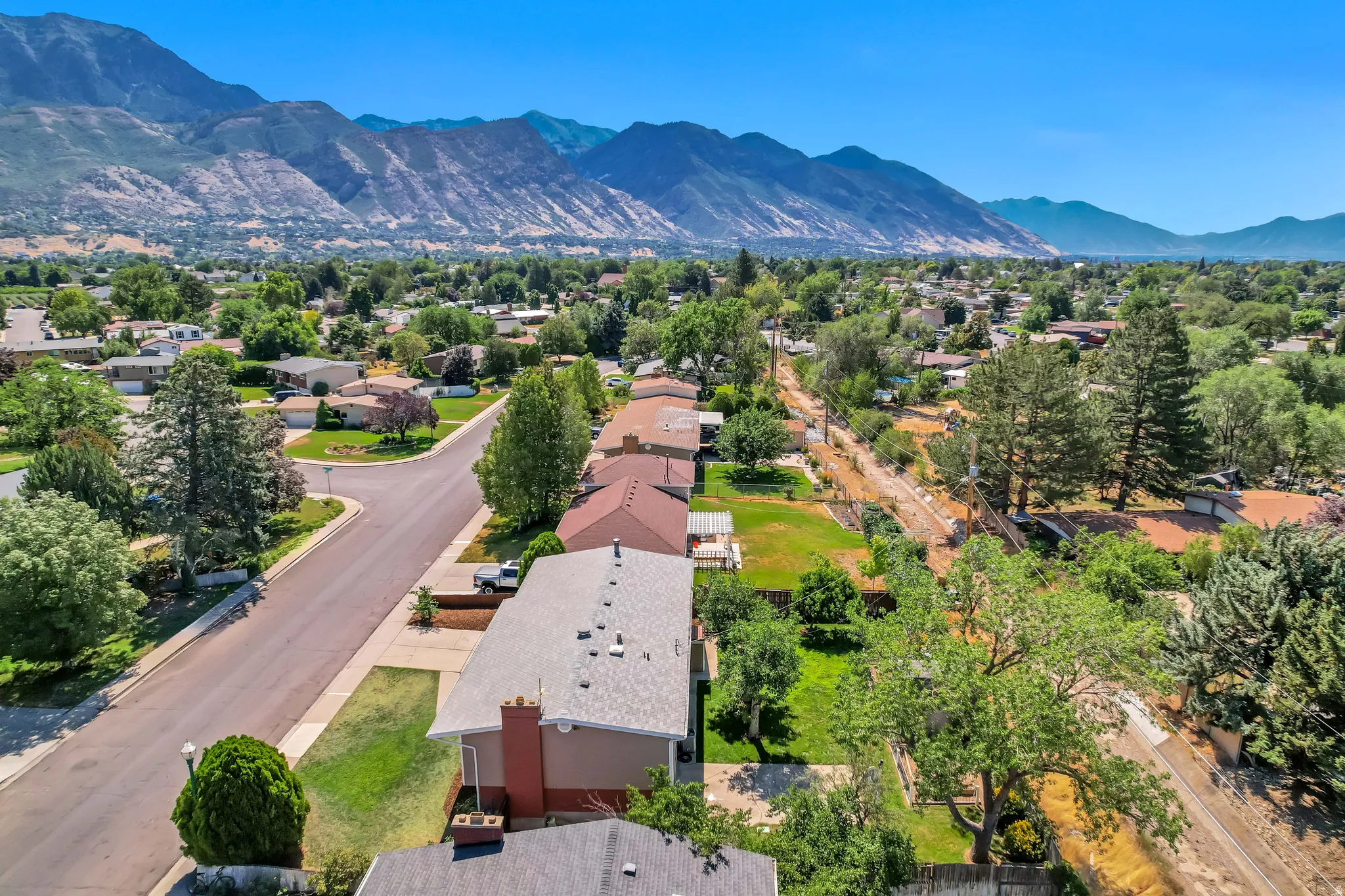 Mountain backdrop framing a residential neighborhood with mature trees