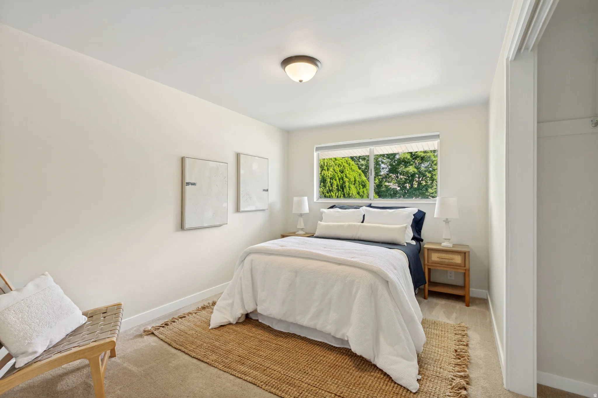 Upstairs room with a large window, neutral wall paint, and recessed closet space