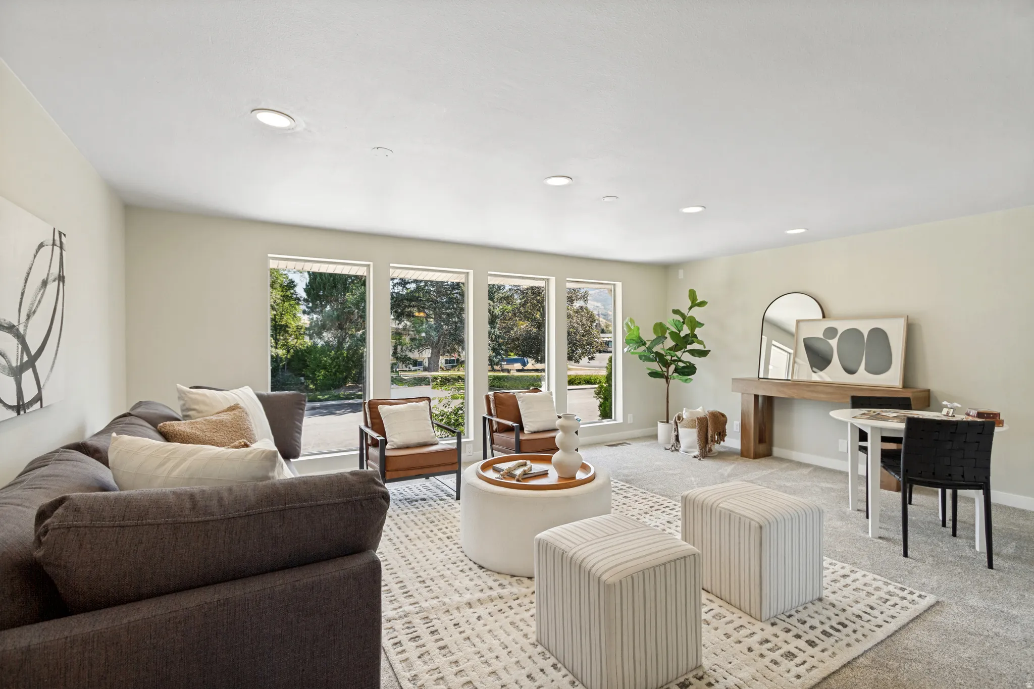 Bright living area featuring recessed lighting, a large picture window, and carpet flooring