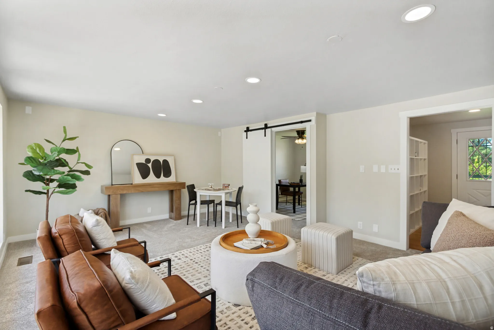 Open-concept living space featuring recessed lighting and light-toned carpeting