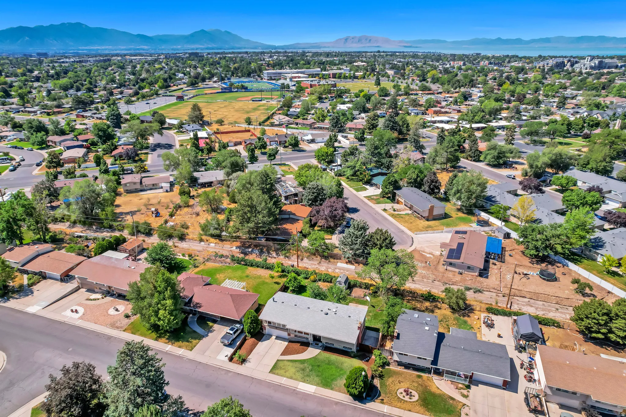 Expansive residential neighborhood featuring numerous mature trees and mountain scenery