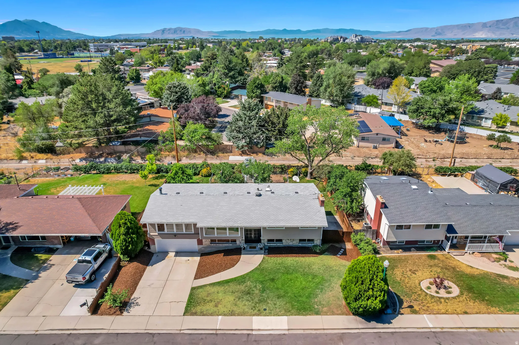 Single-story residence featuring a gray exterior and a light gray shingle roof