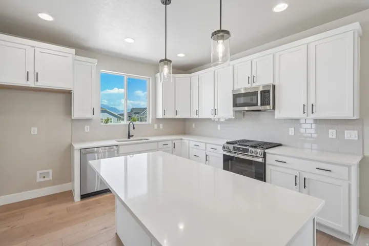 Modern kitchen featuring a large central island with a solid surface countertop