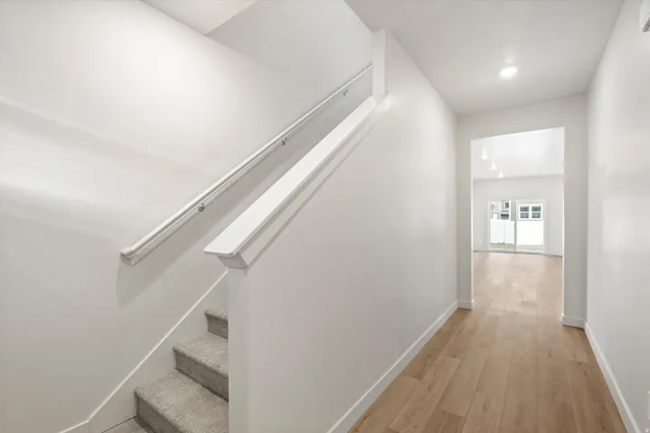 Entryway featuring light wood-finish flooring, white walls, and recessed lighting