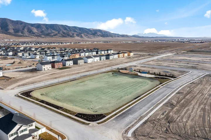 Aerial perspective showcasing a developing community with established residential areas and new construction plots