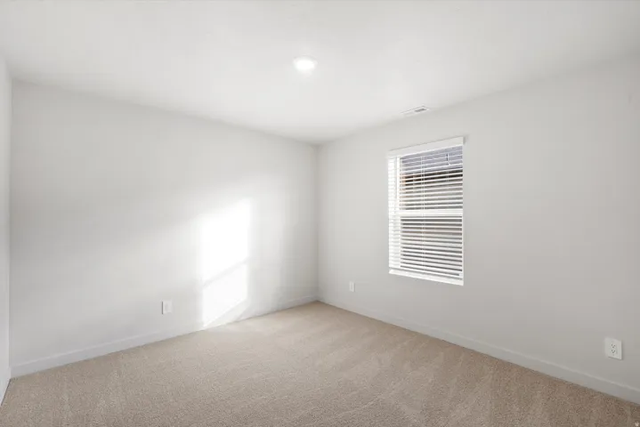 Neutral-toned carpeting complements the light wall color