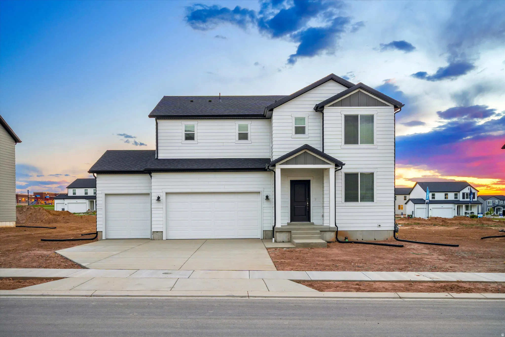 **DISCLAIMER** Exterior elevation may vary. Modern two-story residence featuring white siding and a dark roof
