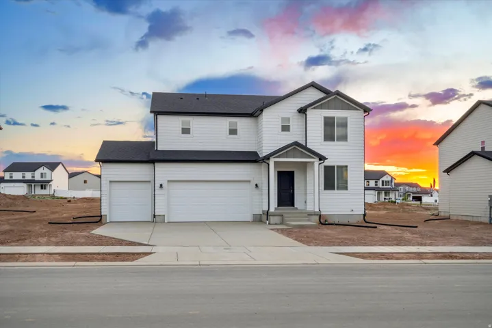 **DISCLAIMER** Exterior elevation may vary. Contemporary two-story residence featuring white siding and dark trim