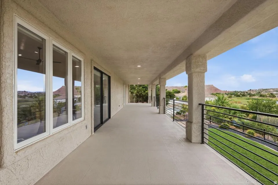 Covered patio with textured stucco walls, recessed lighting, and a durable tile-finish floor