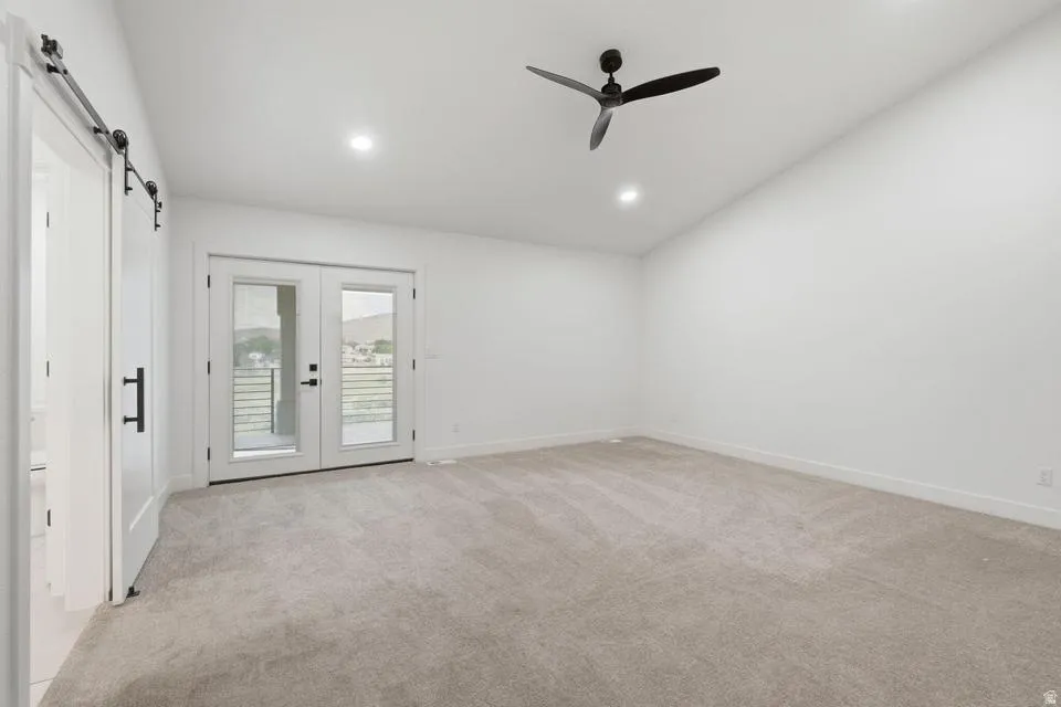 Spacious room with light-toned carpeting and white walls