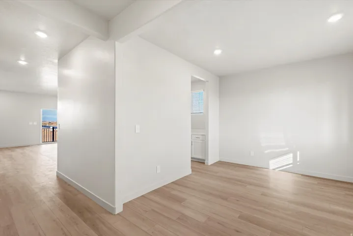 Open-concept room featuring light wood-finish flooring and recessed ceiling lighting