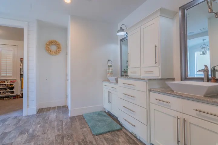 Dual vanity with white cabinetry and light-colored countertops