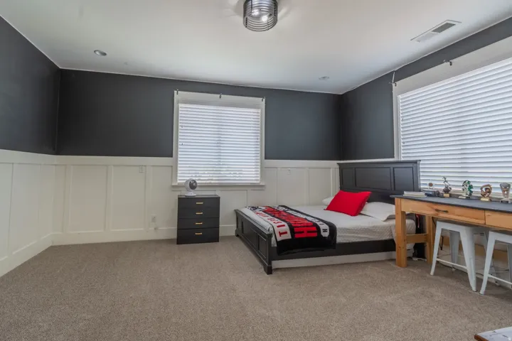 Bedroom featuring wainscoting, recessed lighting, and carpet flooring