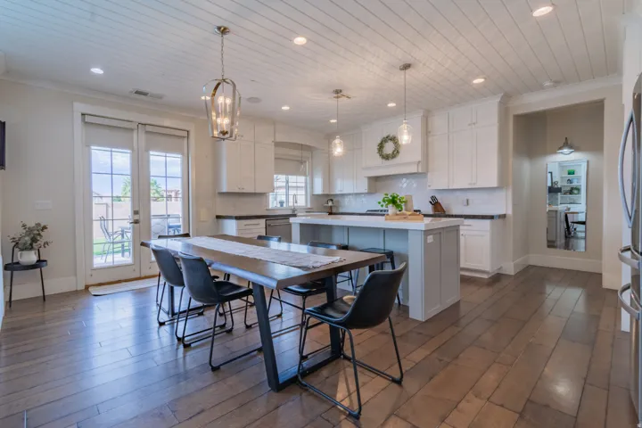 Open-concept kitchen and dining area featuring wide-plank wood-finish flooring, a shiplap ceiling, and recessed lighting