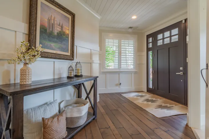 Entryway featuring dark wood-finish flooring, white board and batten wall paneling, and a shiplap ceiling