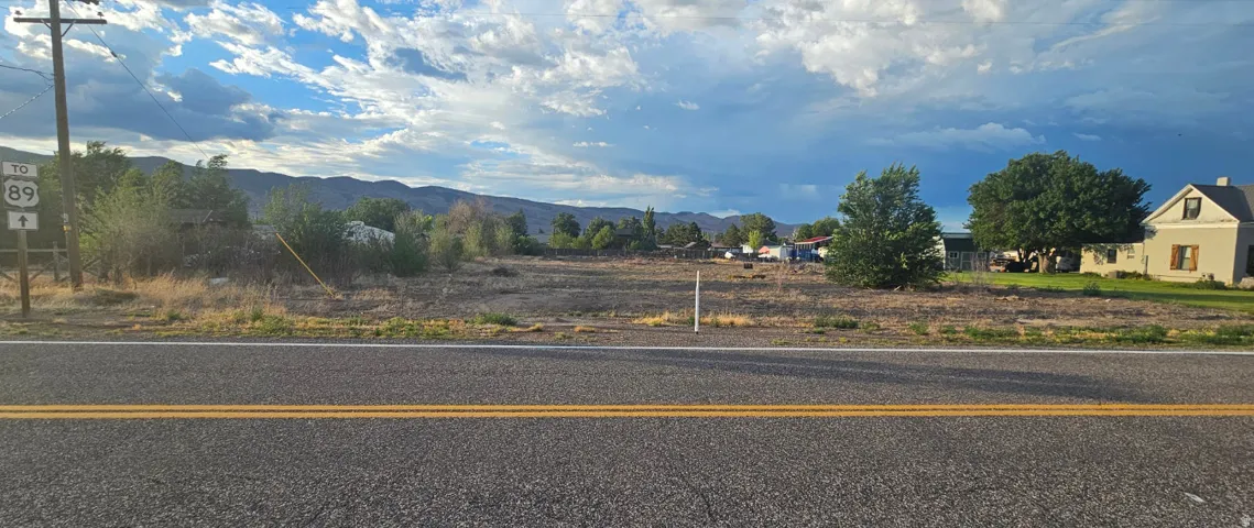 Expansive land parcel featuring direct road frontage, a level grade, and distant mountain vistas