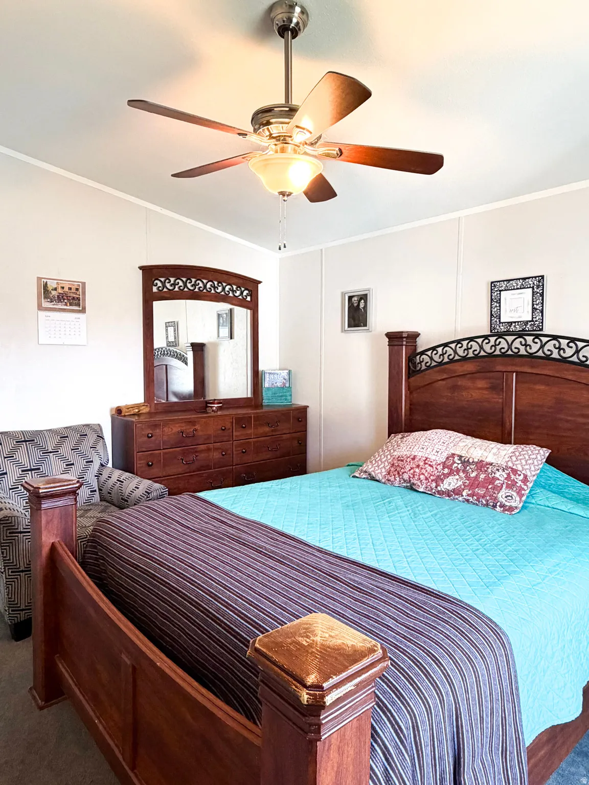 Spacious room featuring a ceiling fan with integrated lighting, white walls, and crown molding