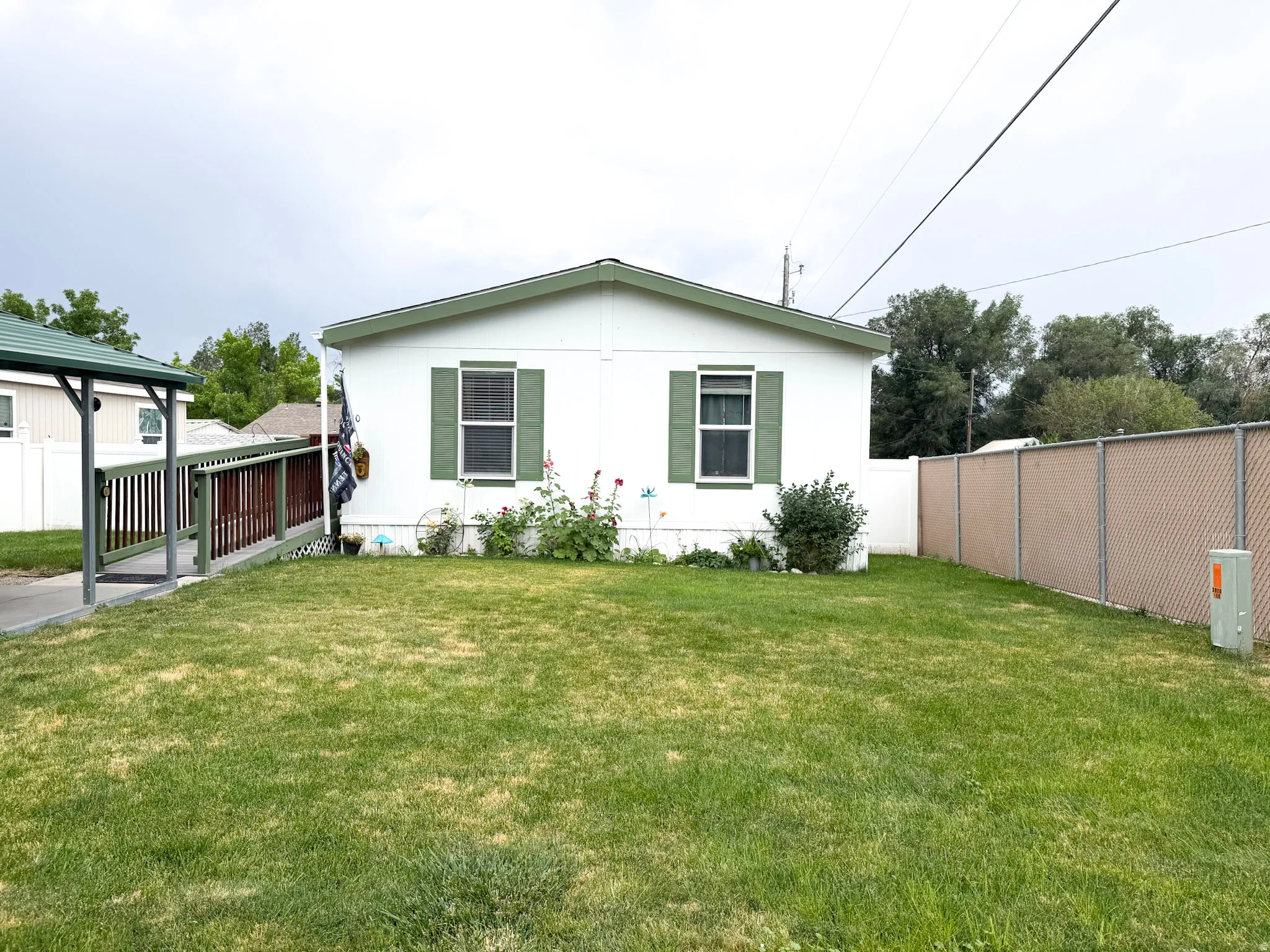 White exterior with green trim and shutters