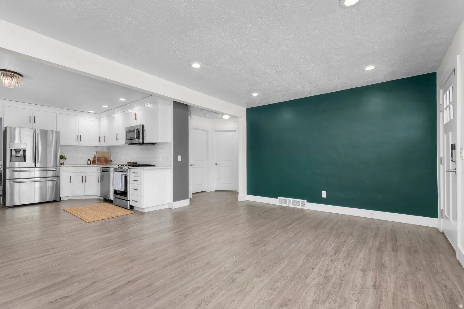 Open-concept living space with wood-finish flooring