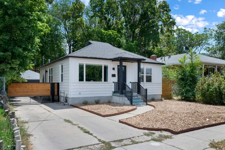 White exterior with a dark grey roof and contrasting black trim