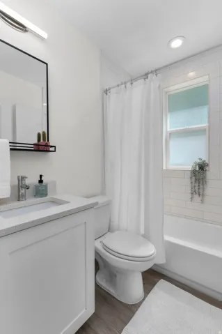 Bathroom featuring a white vanity with a light-toned countertop, a rectangular undermount sink, and chrome fixtures