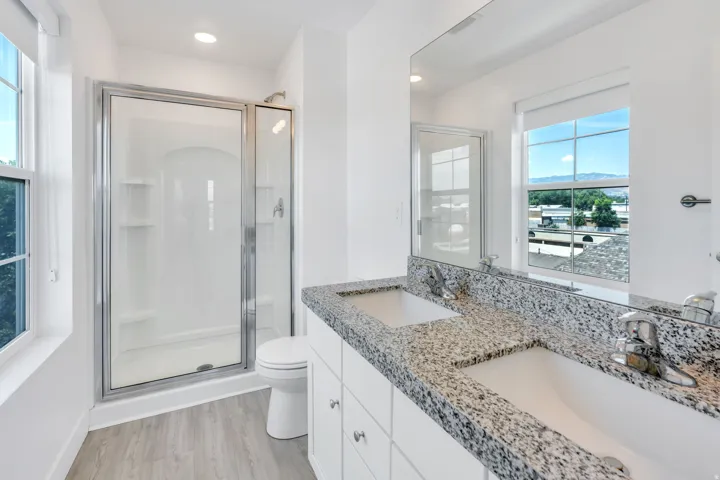 Double vanity with granite countertop and integrated sinks