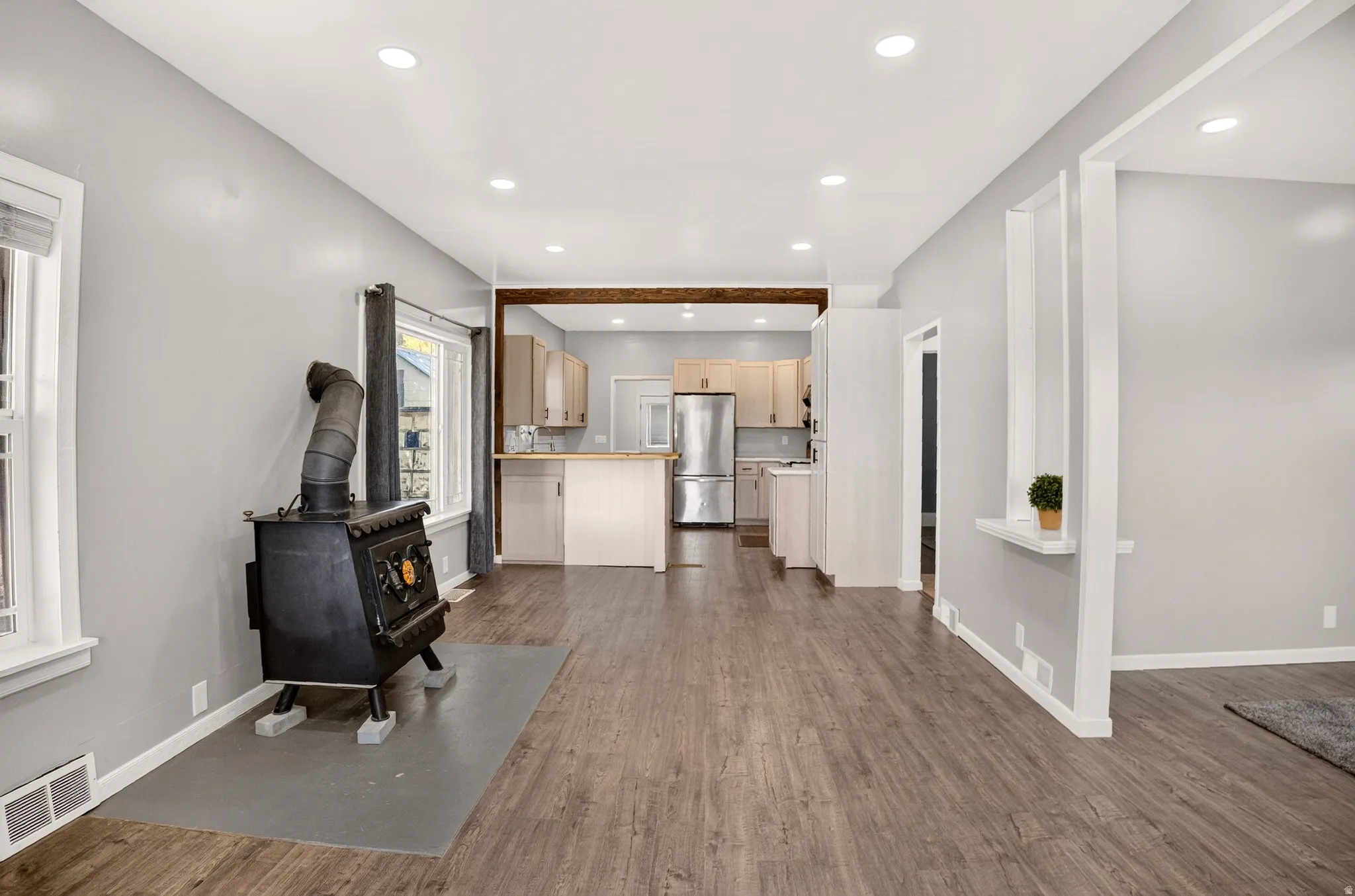 Spacious living area featuring wood-finish flooring and recessed lighting
