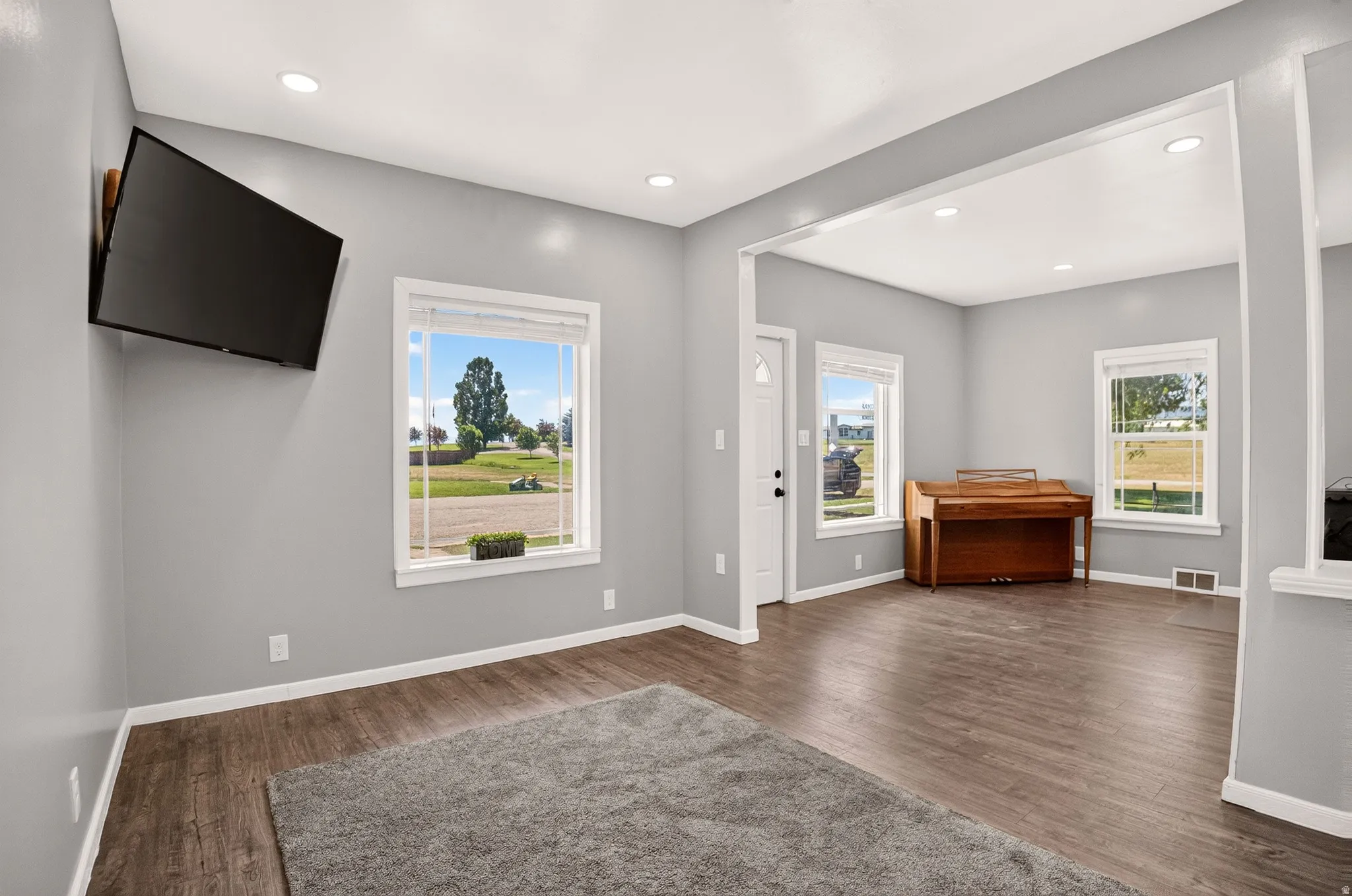 Living space featuring wood-finish flooring and recessed ceiling lights