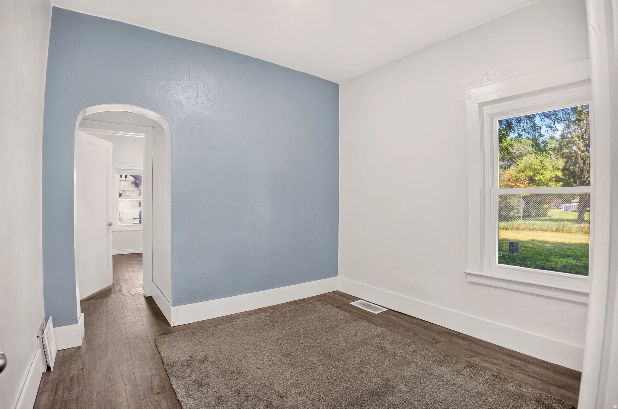 Interior space featuring a light blue accent wall and white trim