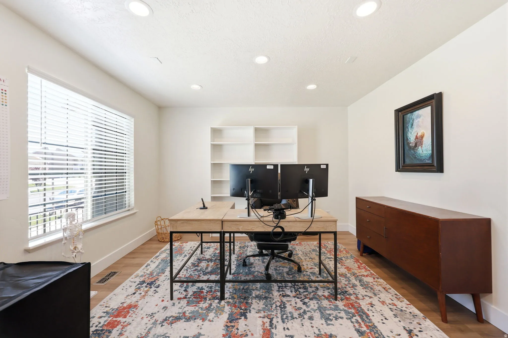Spacious room with wood-finish flooring and a large window