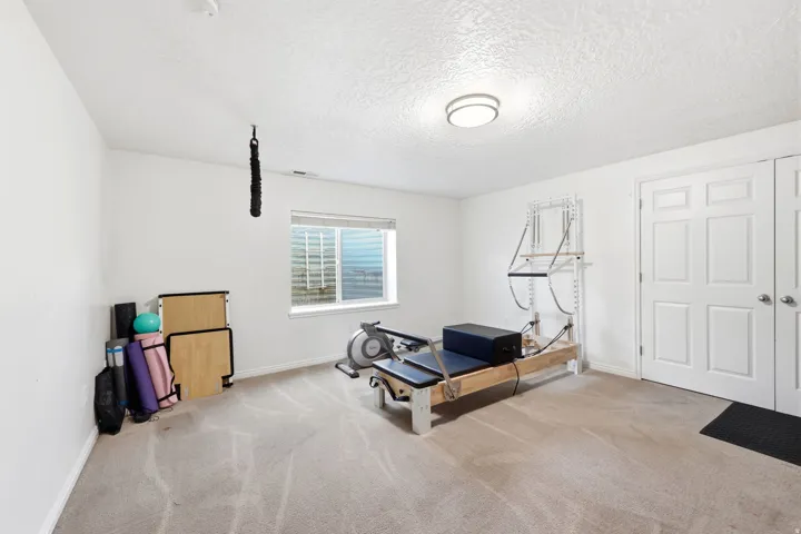 Recessed window providing natural light, accompanied by two paneled doors and an overhead flush-mount light fixture
