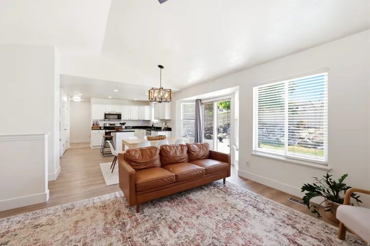 Bright living area with light wood-finish flooring and white walls