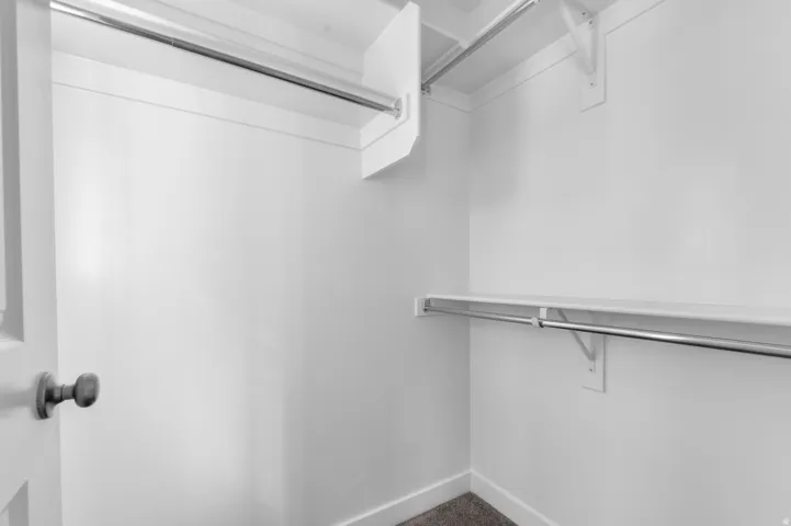 Built-in shelving with chrome hanging rods