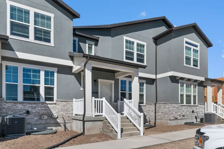 Multi-level stucco exterior with white trim accents