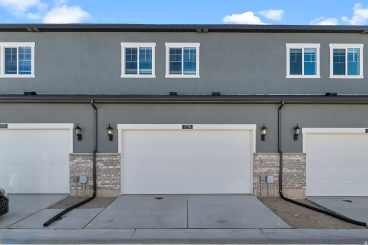 Gray stucco exterior with white-framed windows
