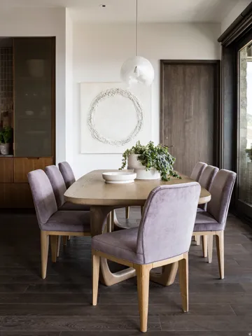 Dining area featuring dark wood-finish flooring and a light-toned dining table