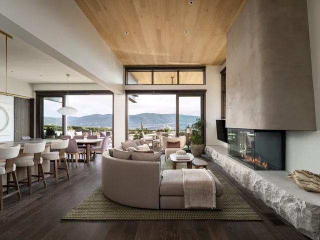 Expansive living space featuring dark wood-finish flooring and a wood-paneled ceiling