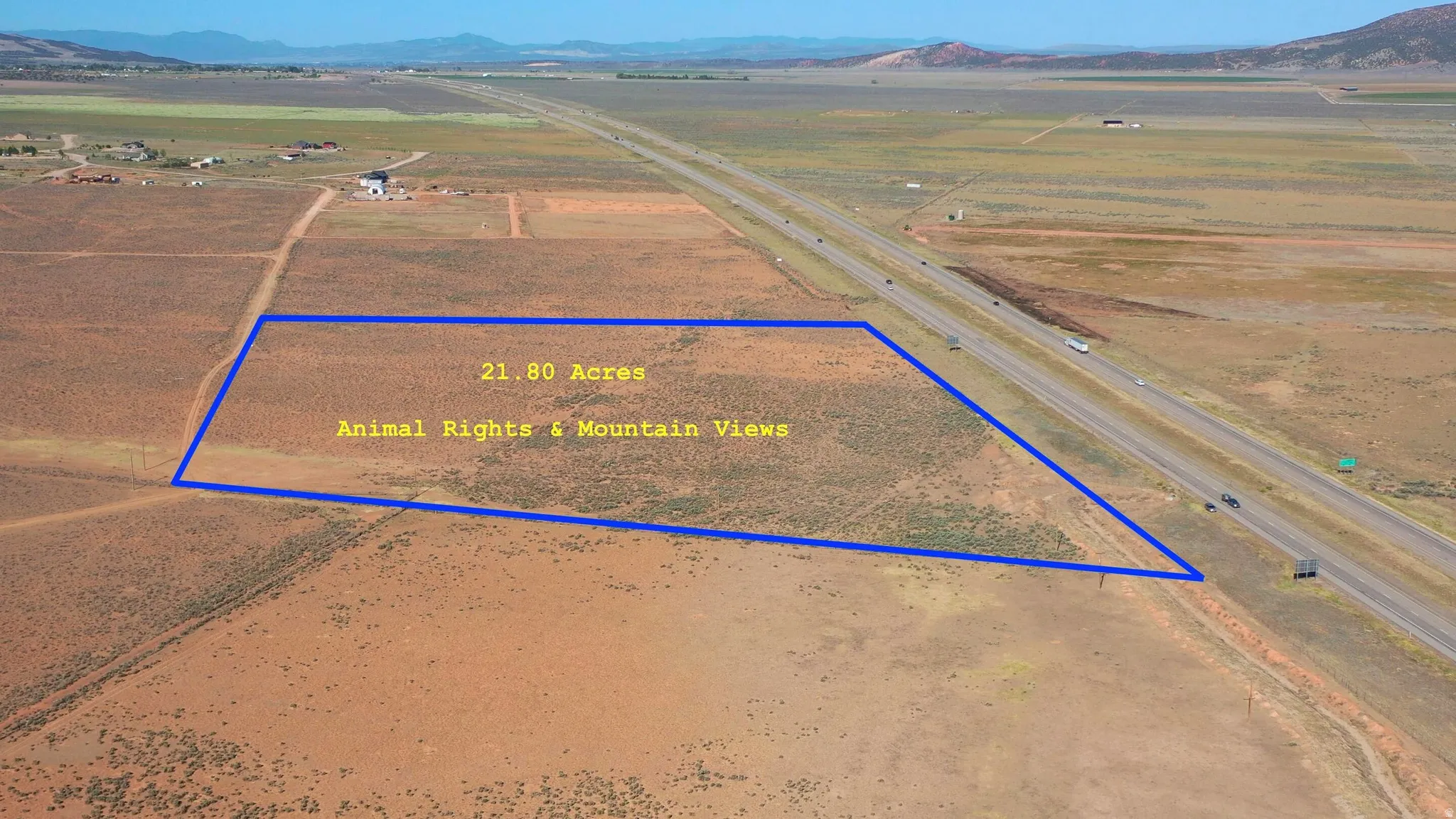 Expansive 21.80-acre parcel outlined in blue, featuring a clear, undeveloped landscape