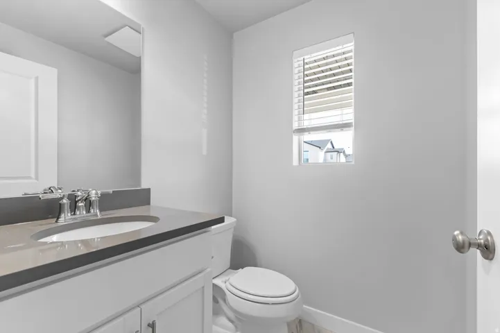 Vanity with a polished chrome faucet, under-mount sink, and integrated countertop
