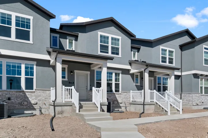 Contemporary exterior with grey stucco siding and white trim