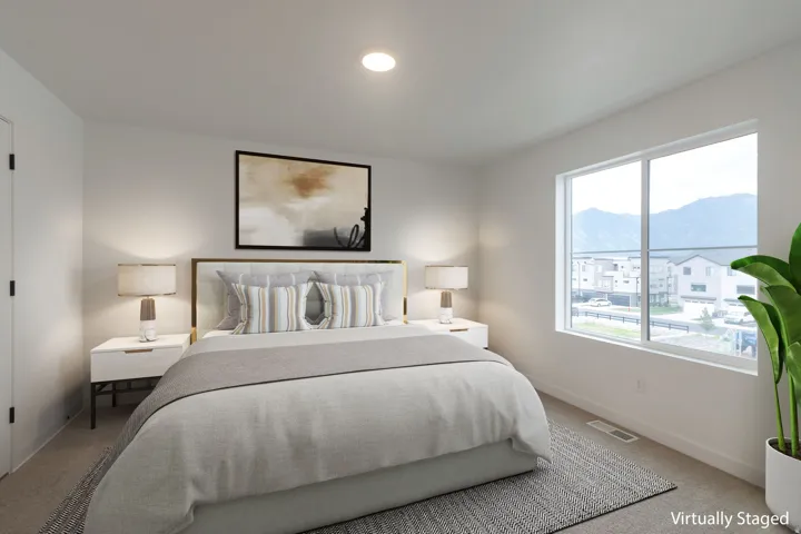 Bright room featuring a large window, recessed lighting, and neutral carpet flooring
