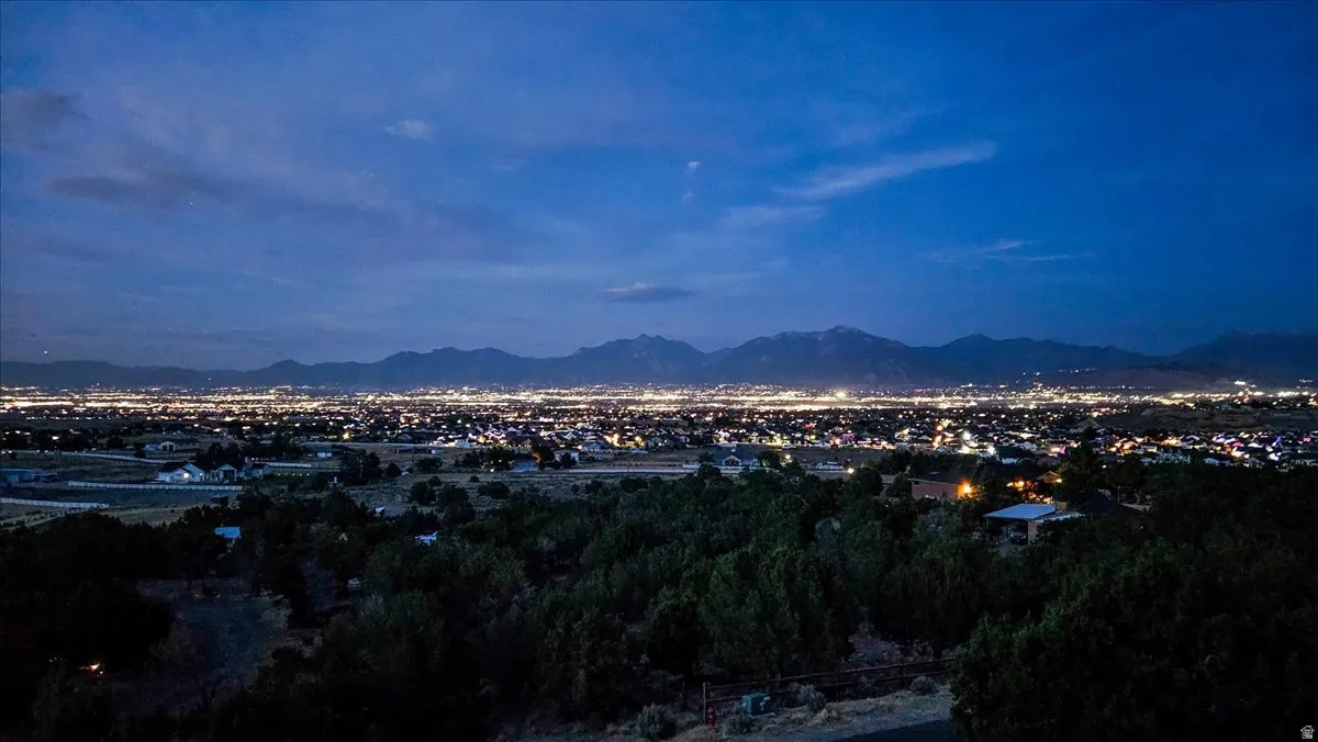 Panoramic city lights and distant mountain ranges