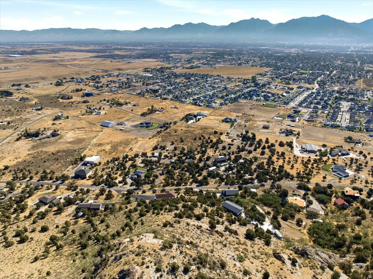 Expansive aerial landscape featuring scattered residential properties amidst natural terrain