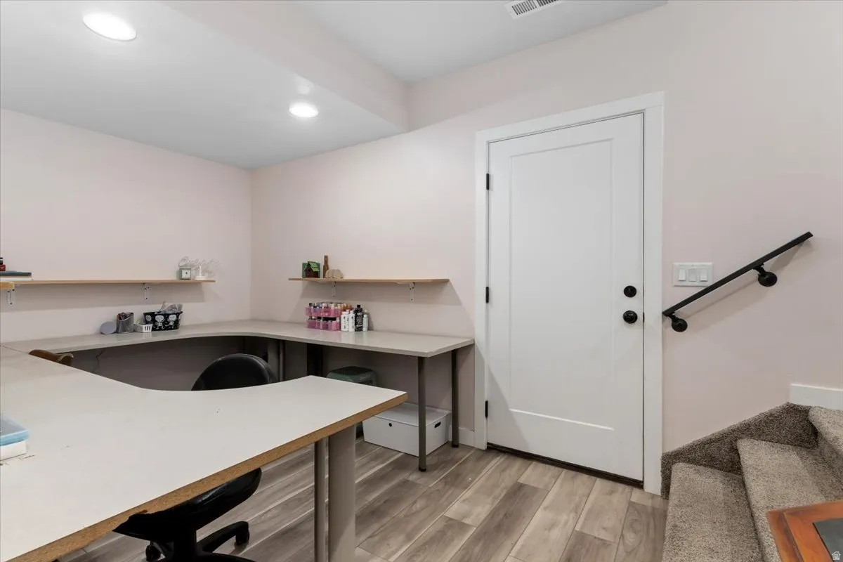 Dedicated workspace featuring extensive built-in countertops and wall shelving