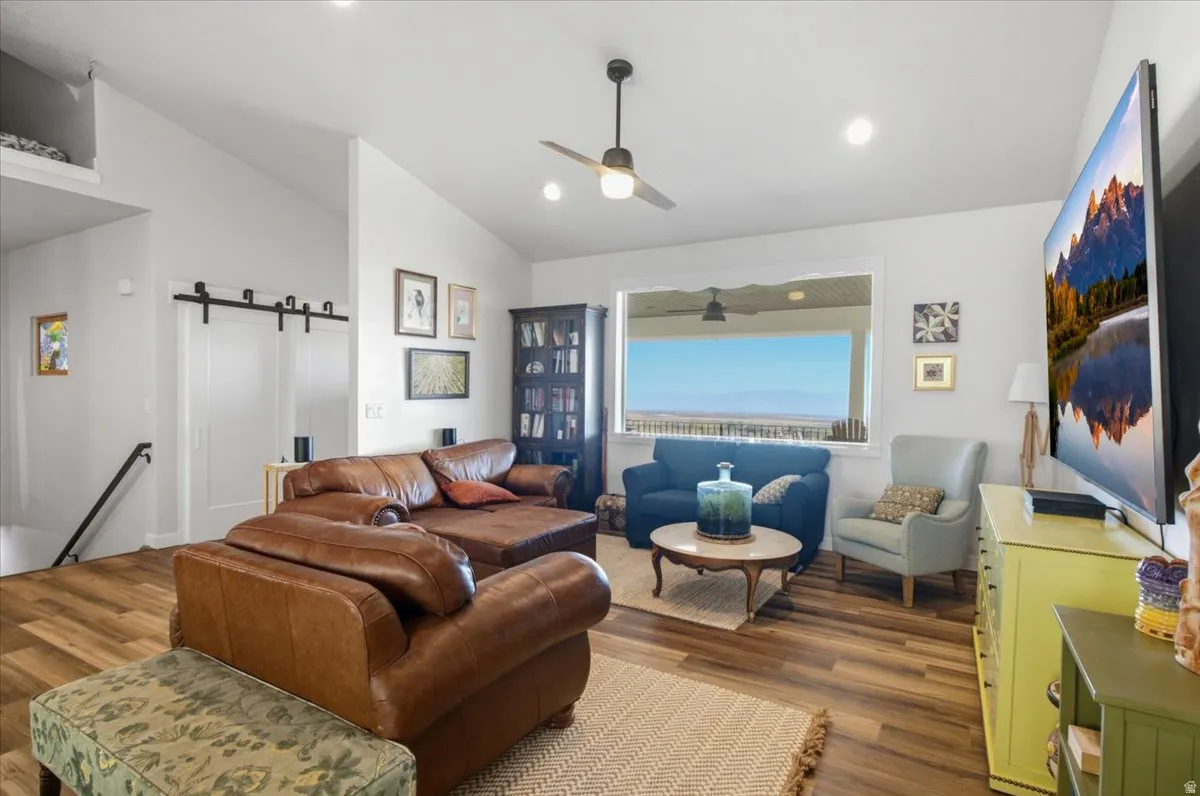 Spacious room with vaulted ceilings and wood-finish flooring