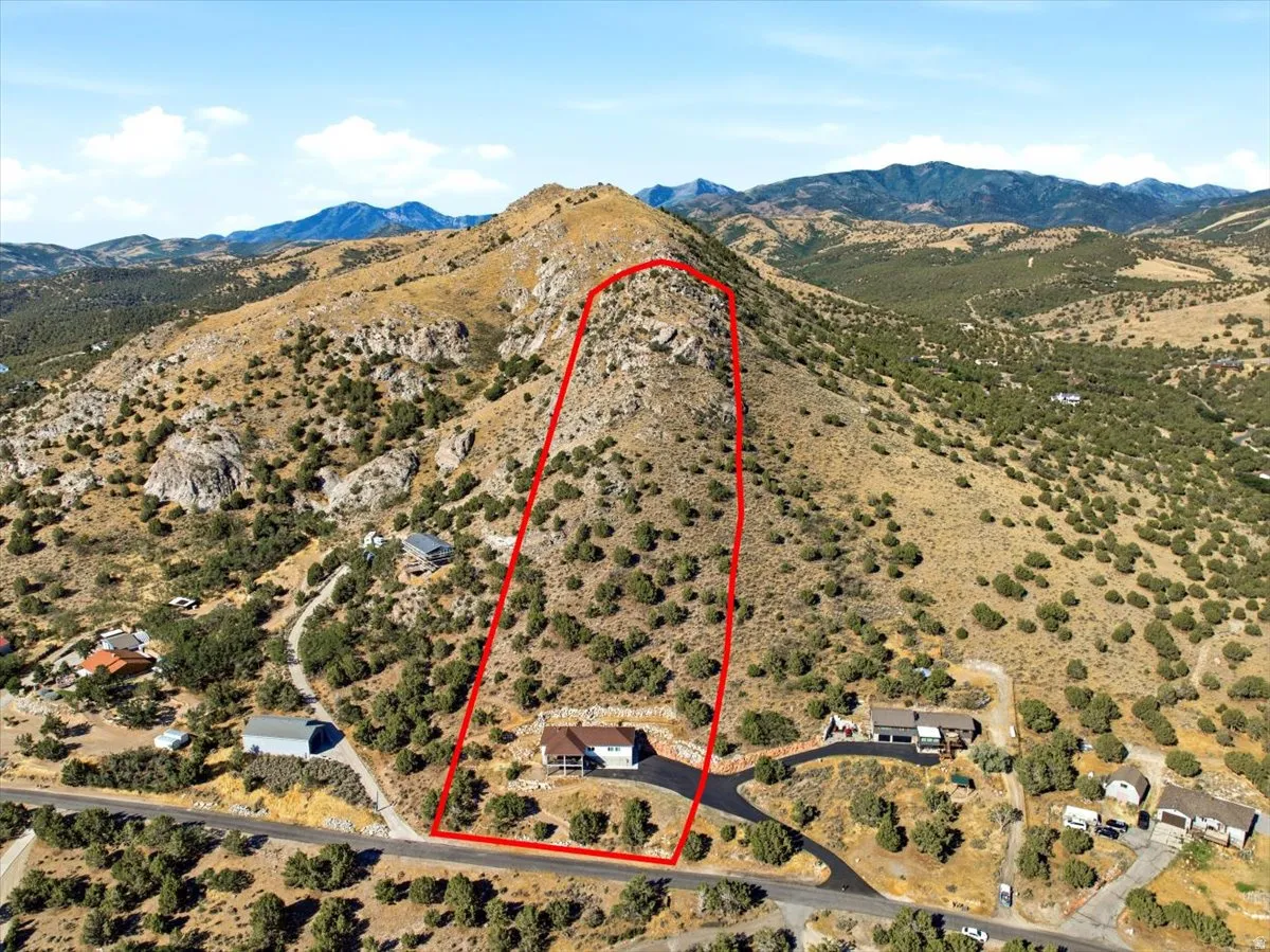 Expansive mountain property featuring a natural, rugged landscape with a prominent hillside