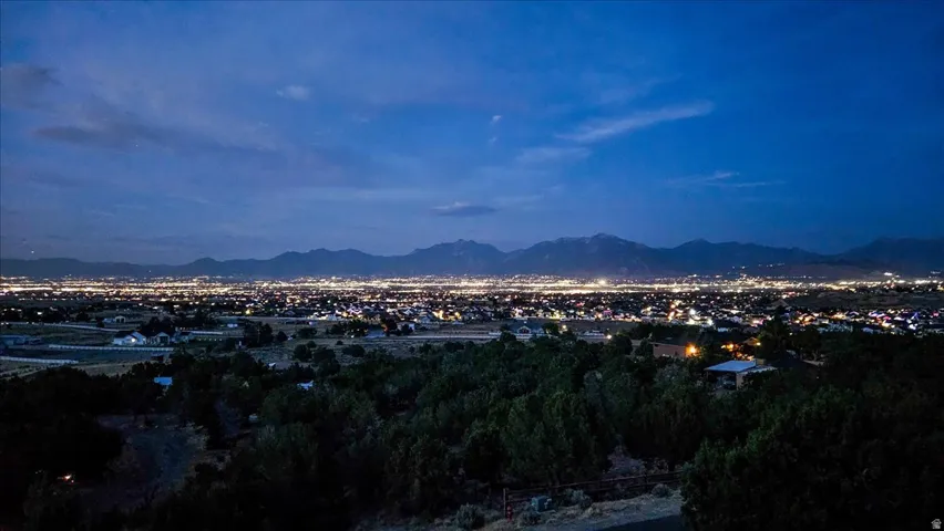 Panoramic city lights and distant mountain ranges
